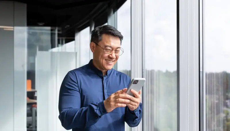 Investor Using His Phone to Invest
